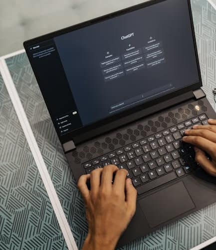 pexels photo 16094047 16094047 Person typing on a laptop with ChatGPT displayed, showcasing modern technology use.